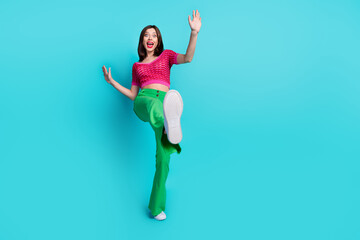 Full length photo of astonished funny cute woman dressed top green pants show shoes falling back...