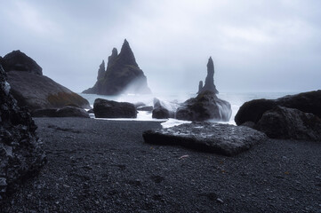 Reynisdrangar dark sea stack at Reynisfjara Beach, Vik, Iceland with moody weather