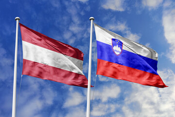 3d illustration. Austria and Slovenia Flag waving in sky. High detailed waving flag. 3D render. Waving in sky. Flags fluttered in the cloudy sky.