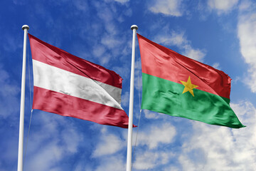3d illustration. Austria and Burkina Faso Flag waving in sky. High detailed waving flag. 3D render. Waving in sky. Flags fluttered in the cloudy sky.