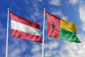 3d illustration. Austria and Guinea-Bissau Flag waving in sky. High detailed waving flag. 3D...