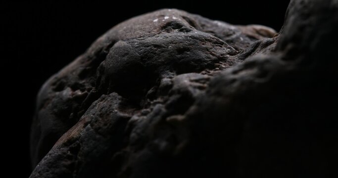 Meteorite-like Boulders Against the Void. Close-up, shallow dof.