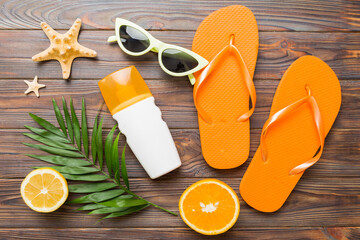 Top view composition of flip flops placed with beach accessories top view on table background....