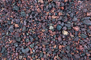 Colorful gravel around Kerid Crater, a dormant volcano crater in Iceland