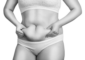 Woman holding her own belly fat.