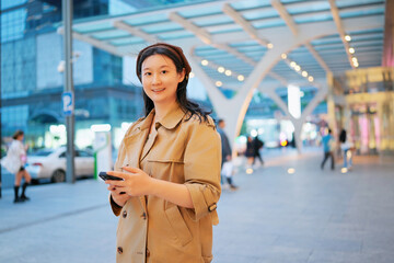 Confident Businesswoman Using Smartphone in City