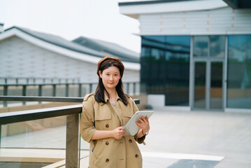 Confident Professional Woman with Tablet Outdoors