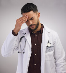 Studio, man or doctor in pain of headache, burnout and mental health of medical employee. Tired, healthcare male worker and stress with migraine, anxiety and overworked pressure by white background