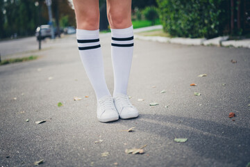 Photo portrait of lovely teen lady sneakers legs schoolgirl dressed stylish uniform garment autumn park sunny day background