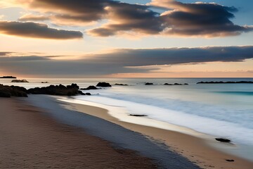 Obraz premium A beautiful sunset over a calm ocean with vibrant orange and pink hues reflecting on the water. 