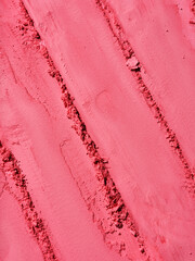 Full background of red makeup powder texture. Bold geometrical pattern of cosmetic product. Macro...