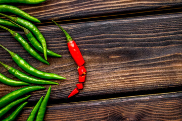 Cooking hot food with chilli pepper on wooden table background top view copy space