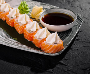 Gourmet sushi platter with cream cheese and soy sauce