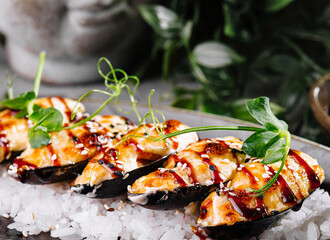 Gourmet grilled mussels on bed of rice