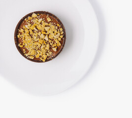 Delicious chocolate tart with nuts on white plate