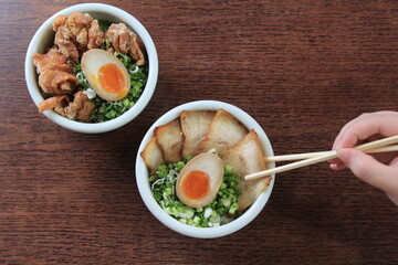 A steaming bowl of ramen featuring perfectly marinated pork belly nestled amongst springy noodles, crowned with a soft-boiled egg.