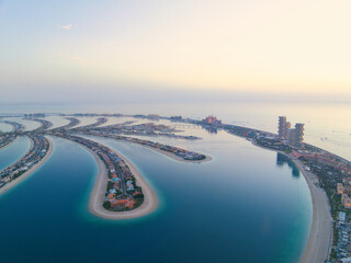 Aerial panoramic view of Palm Jumeirah islands during sunset in Dubai