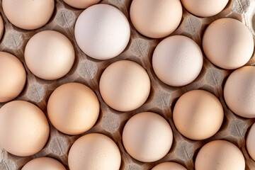 Brown eggs stacked in rows.Group of Fresh white Eggs in a cardboard cassette. Organic food from...