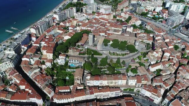 Aerial helicopter view of Le Suquet the old town located in Cannes France fortified tower and Chapel of saint Anne house the Museum de la Castre a distinctive building of Russian Orthodox church