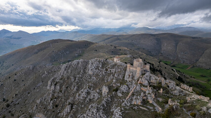 Fototapeta premium Rocca Calascio at sunset with cold light and threatening clouds