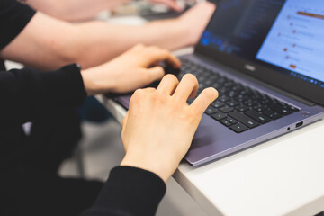 Software developer students in auditorium hall working on computer and laptop, programming contest...