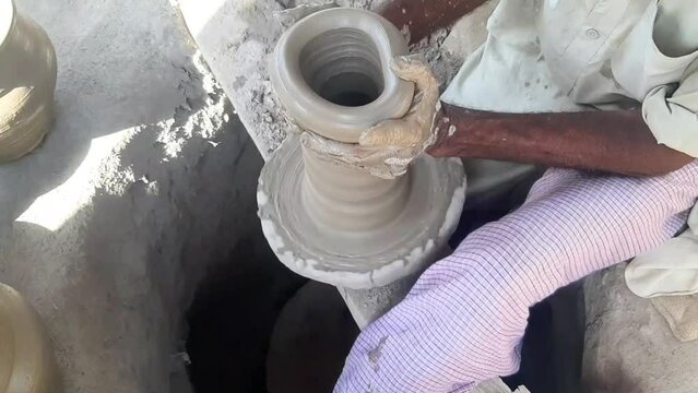 Potter's making pottery art traditional pottery concept. Handmade pottery  in Pakistan. Experienced male potter's hands creating beautiful clay product. Handmade, workshop, pottery. 4K footage.