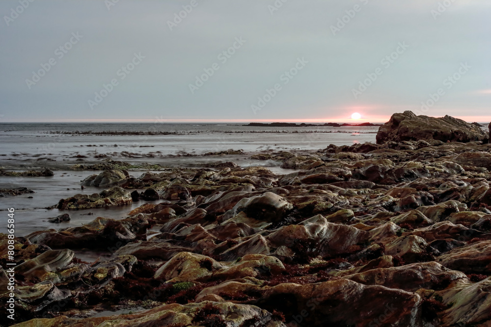 Wall mural Rocky coast at sunset