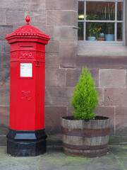 Obraz premium traditional bright red cast iron British Victorian octagonal post or mail box