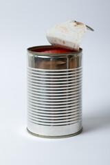 opened tin can with tomato sauce on white background
