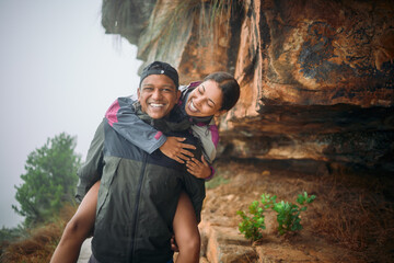Hiking, hug and couple with nature, vacation and rain with adventure, journey and romance. Outdoor,...