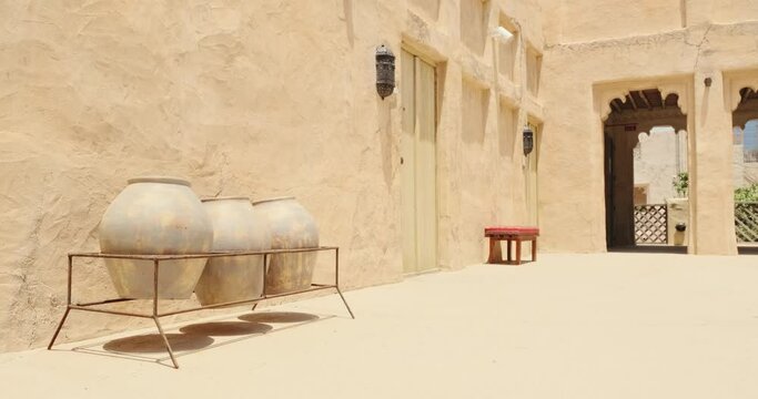 Large Antique Traditional Clay Jars and Pots Standing in Row. Huge Clay pots. Ceramic old dishes. Water clay pots. Old Pottery. Earthen jar. Earthen pots near old heritage building, Dubai, UAE