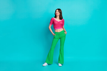 Full size photo of good mood gorgeous girl wear pink top arms in pockets look at sale empty space...