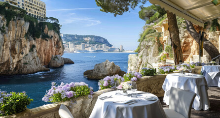 Dining tables were set up on the terrace of an elegant restaurant with a sea view in Monaco, overlooking lush greenery and blue waters