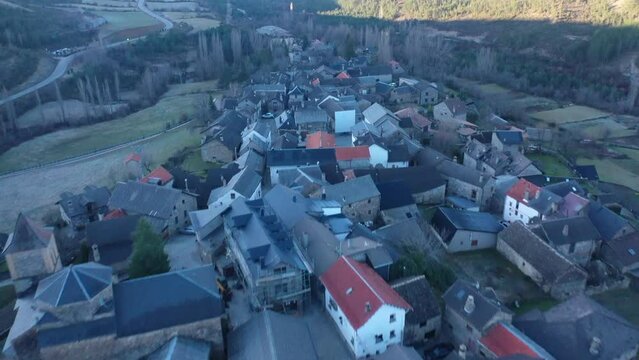 Aerial video over a small town in the Pyrenees in Andorra with the church