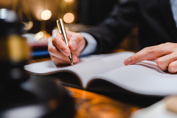 Successful businessmen's hand putting signing contract or agreement form, Lawyers or attorneys sign approval document, concept of justice, corporate, justice and rights, insurance, court and authority