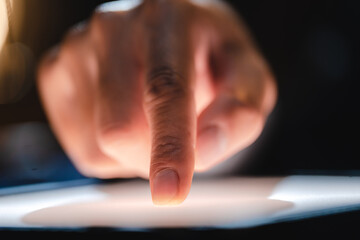 Hand or finger pointing or touching a mobile phone or tablet screen, concept of social media cyberspace, message or text, Blur and white screen, smartphone networking, connection and communication.