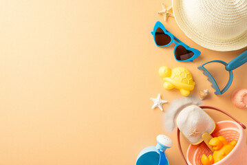 Top view of beach accessories including hat, sunglasses, toys, and starfish carefully arranged on a...