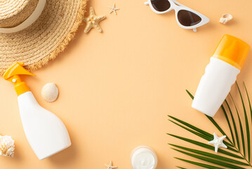 An arrangement of summer beach essentials on beige background, featuring sunscreen sprays,...
