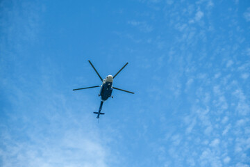 A transport helicopter in flight against the sky.