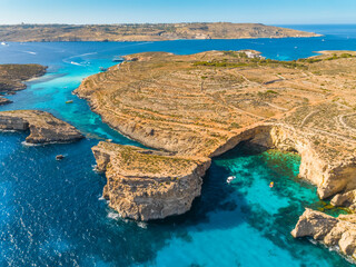 Aerial drone view of Crystal lagoon on Comino island. Boats. Mediterranean sea, Malta