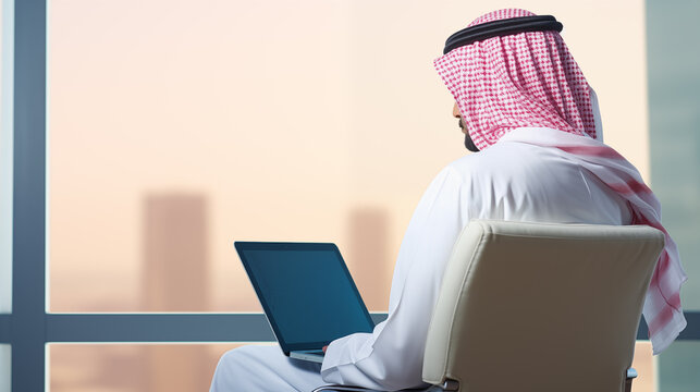arab saudi man using laptop, back view