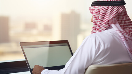 arab saudi man using laptop, back view