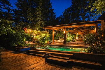 Wooden outdoor veranda. Suburban terrace with pool at night light. - 808913409