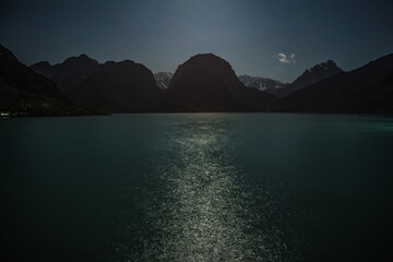 Night landscape panorama of Lake Iskanderkul with the starry sky on a full moon © Denis