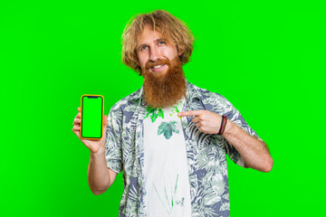 Young developer business man hold smartphone with green screen chroma key mock up recommend good application promotional sale offer. Freelancer redhead bearded guy isolated on green studio background