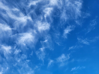 Beautiful blue sky and feathery white clouds nice bright day.