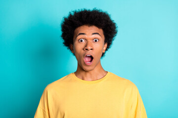 Photo of astonished speechless guy with afro hairdo dressed yellow t-shirt staring open mouth...