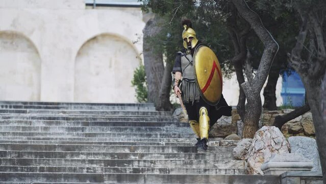 Ancient hoplite warrior or gladiator at Acropolis stairs in Athens, Greece, slow motion