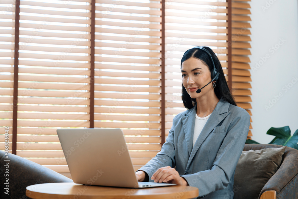 Aufkleber female call center operator or customer service helpdesk staff working on workspace while talking on