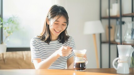 Young woman making coffee at home. She is smiling and looks happy. The photo is taken from a side angle.